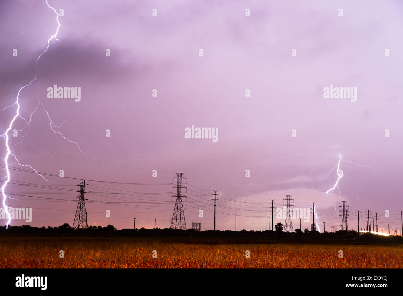 Lightning strikes behind the lines designed to carry it in South Texas Stock Photo