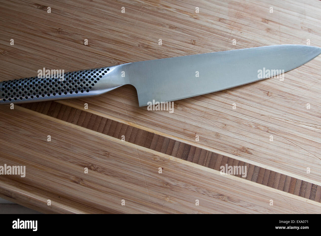 Chef's knife on a bamboo cutting board. Stock Photo