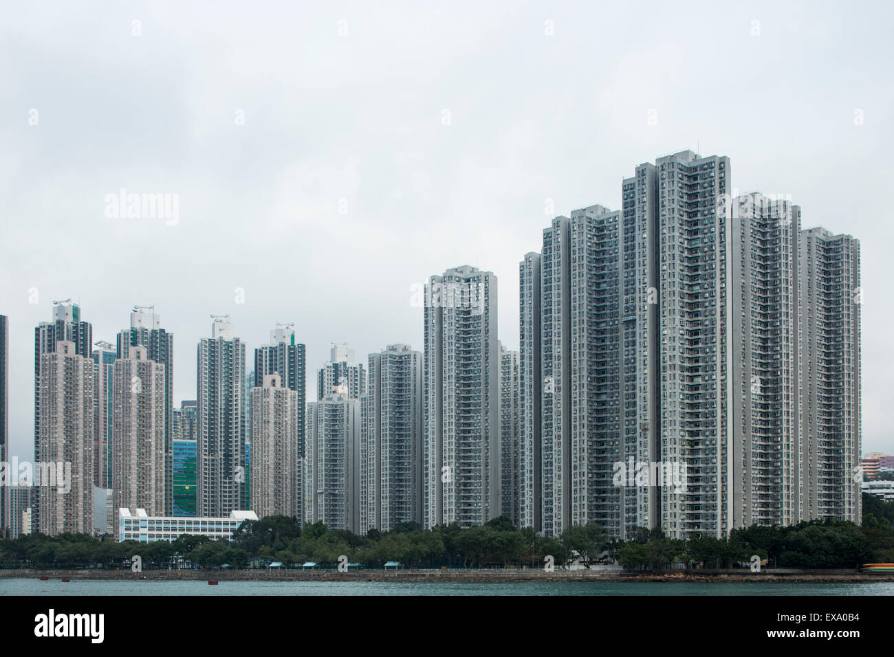 China, Hong Kong, Row of apartment towers lining bay on Tsing Yi Island Stock Photo