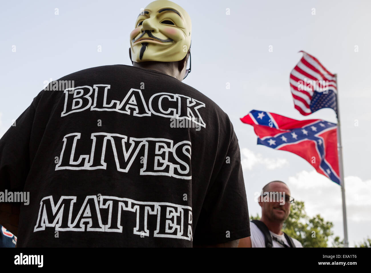 Columbia, South Carolina, USA. 09th July, 2015. A protester outside the South Carolina State House as Governor Nikki Haley signs into law a bill to remove the Confederate flag from the capitol July 9, 2015 in Columbia, SC. The movement to remove the symbol of white supremacy gained momentum after the shooting of nine black people in Charleston last month. Stock Photo