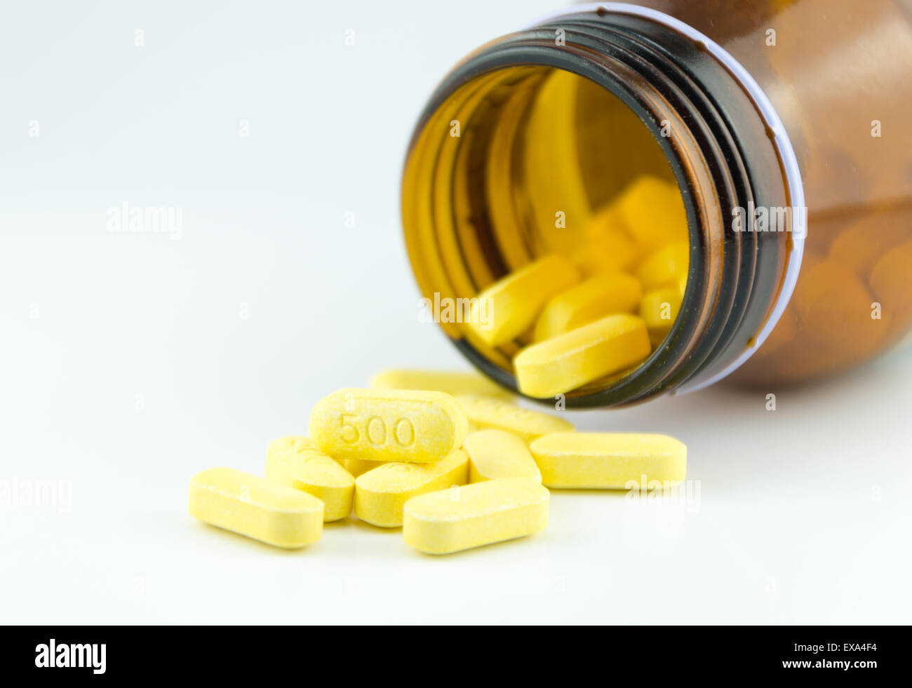 The flow of pills from a brown bottle. Stock Photo