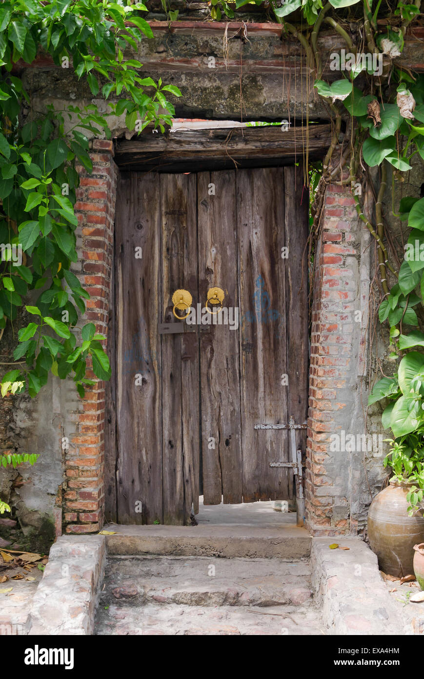 Ancient wooden gate with the inclination and decay. Stock Photo