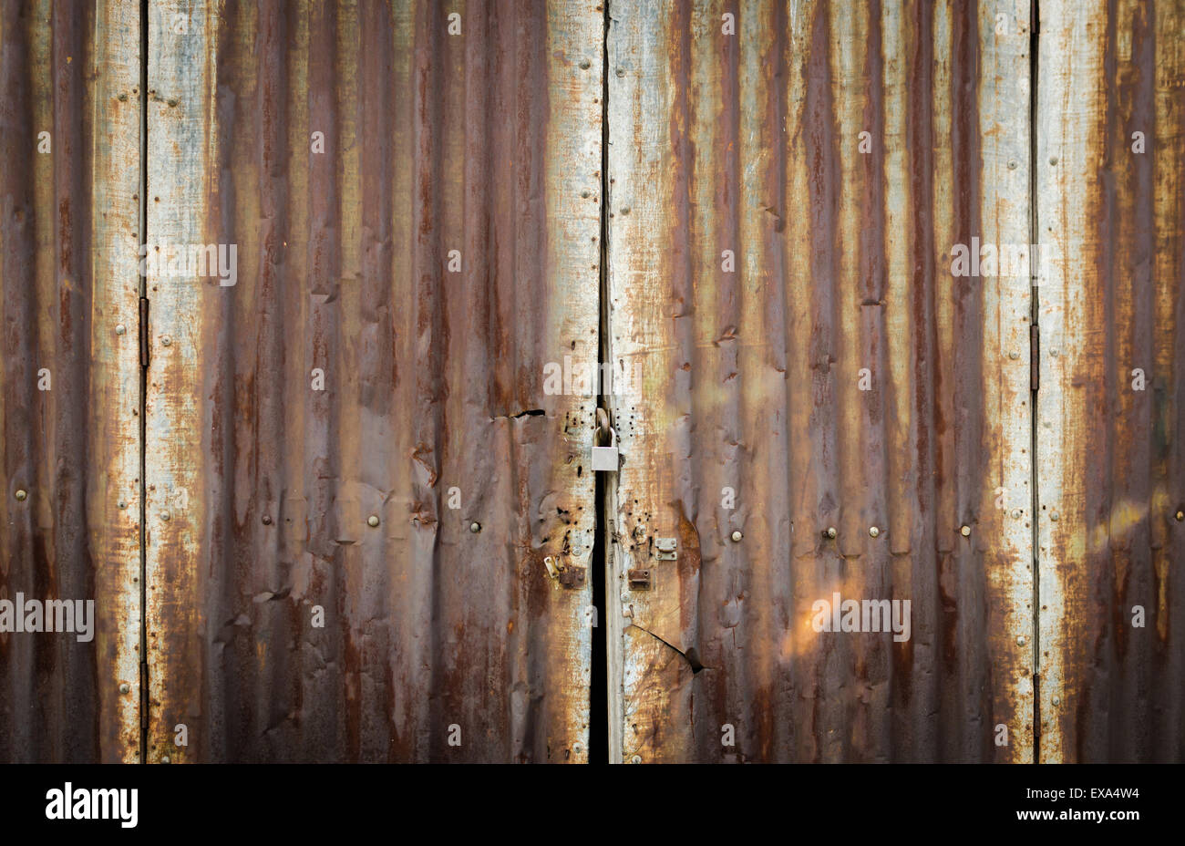 pattern of rusty grunge zinc door with master key lock Stock Photo