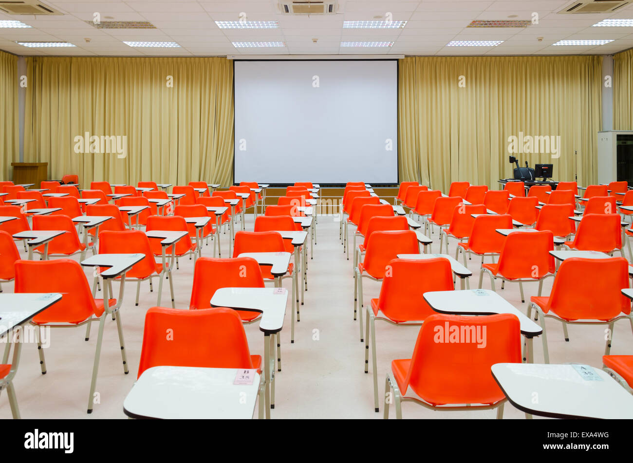 empty classroom, orange chairs and screen Stock Photo