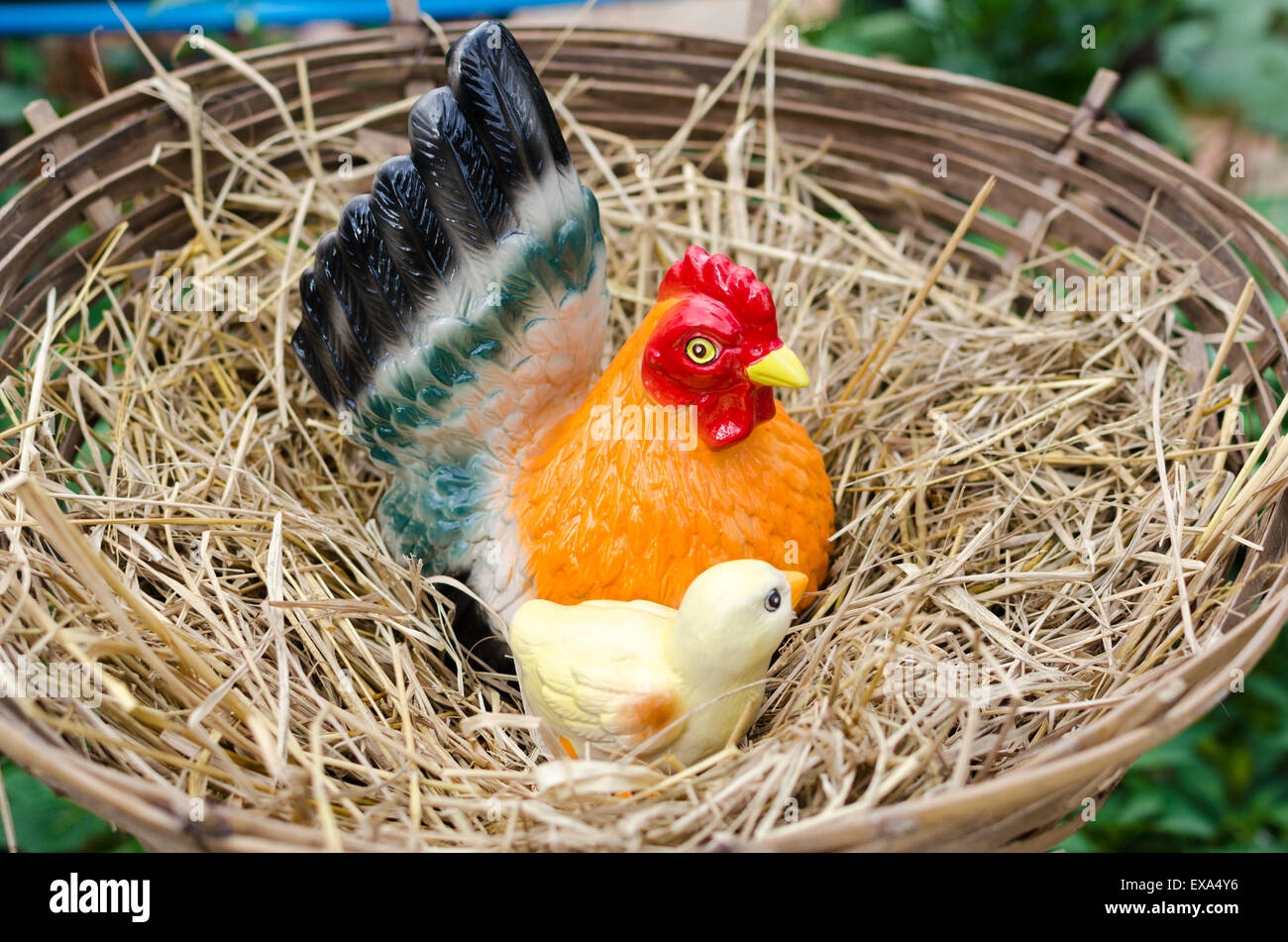Statue of chickens on a pile of straw. Stock Photo