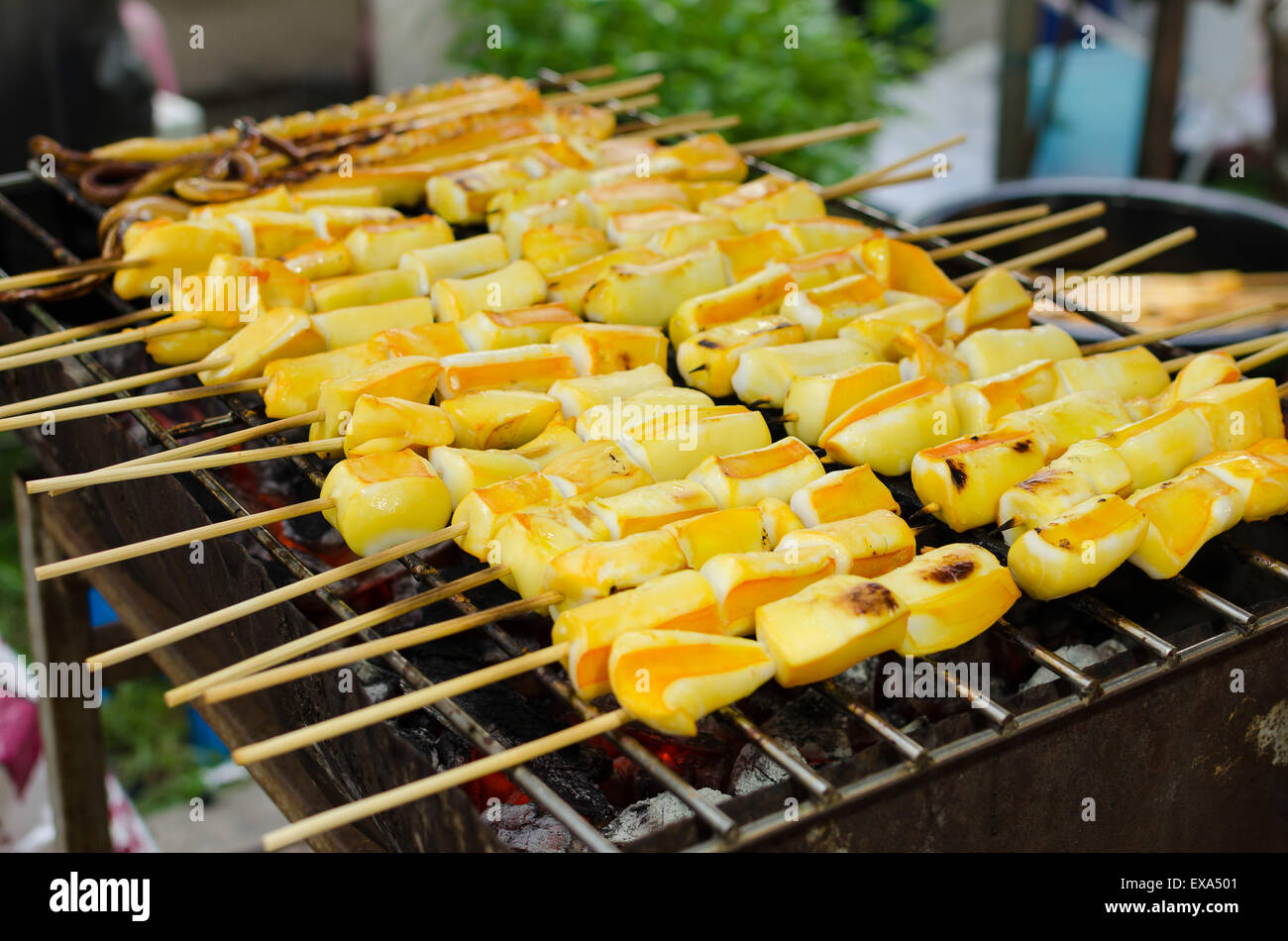 Grilled squid skewers on charcoal Colorful appetizing Stock Photo
