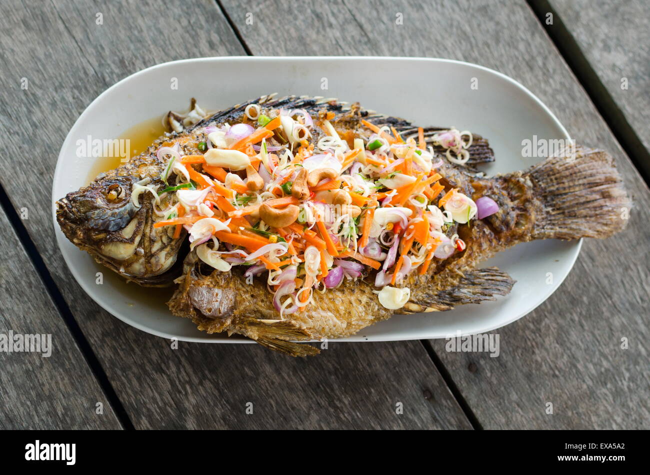 Deep fried red tilapia with herb and spicy sauce, Thai food Stock Photo