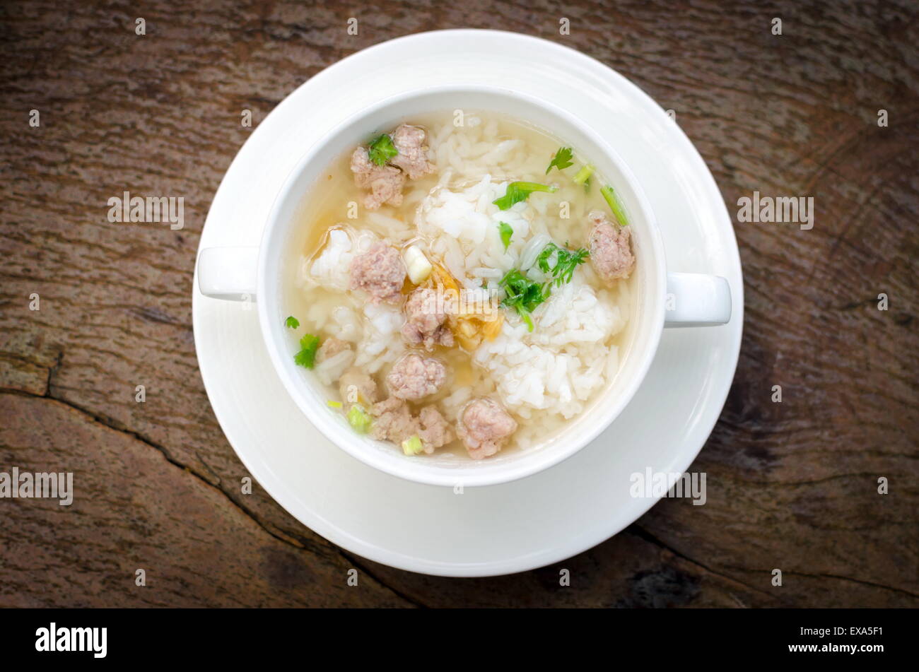 Boiled rice with pork in white  bowl. Thailand is a popular breakfast. Stock Photo