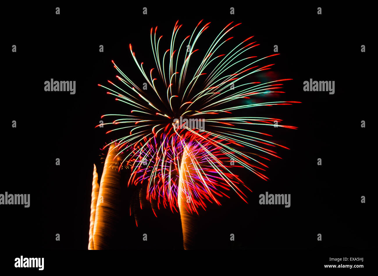 An image of exploding fireworks at night. Represents a celebration. Stock Photo