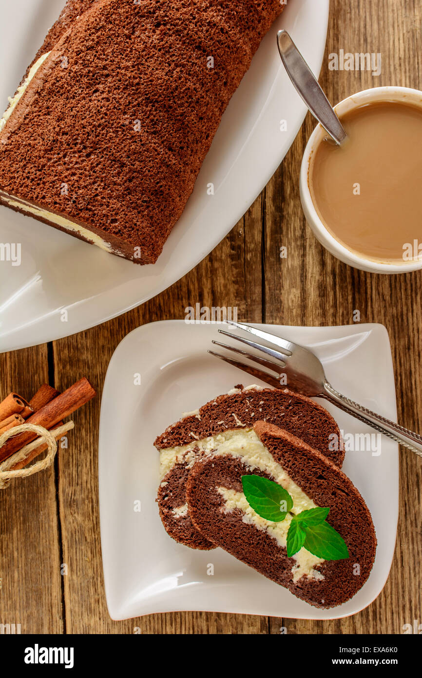 Chocolate roll dessert with coffee on wood table Stock Photo