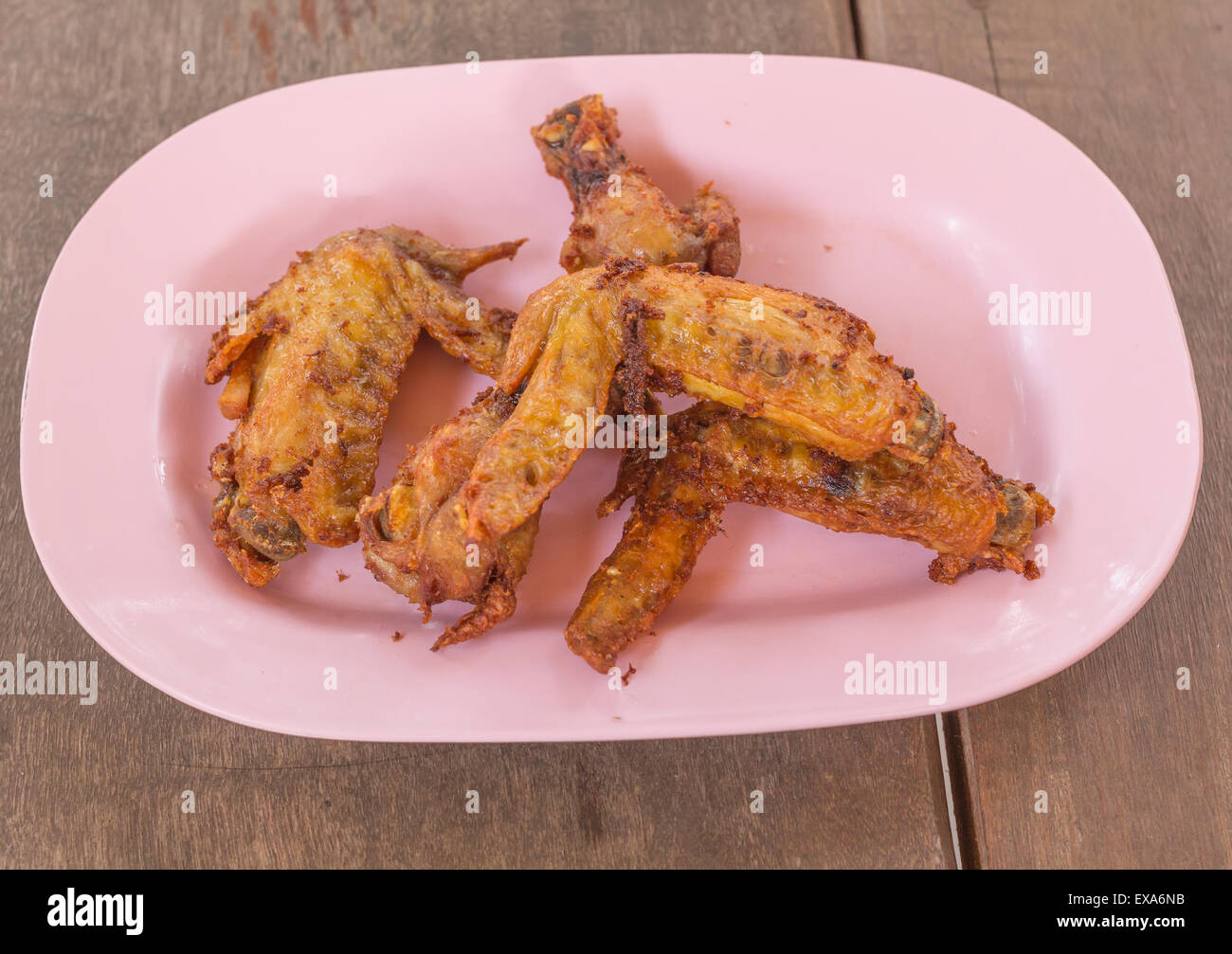 Fried chicken wings on dish plate over wood background Stock Photo Alamy