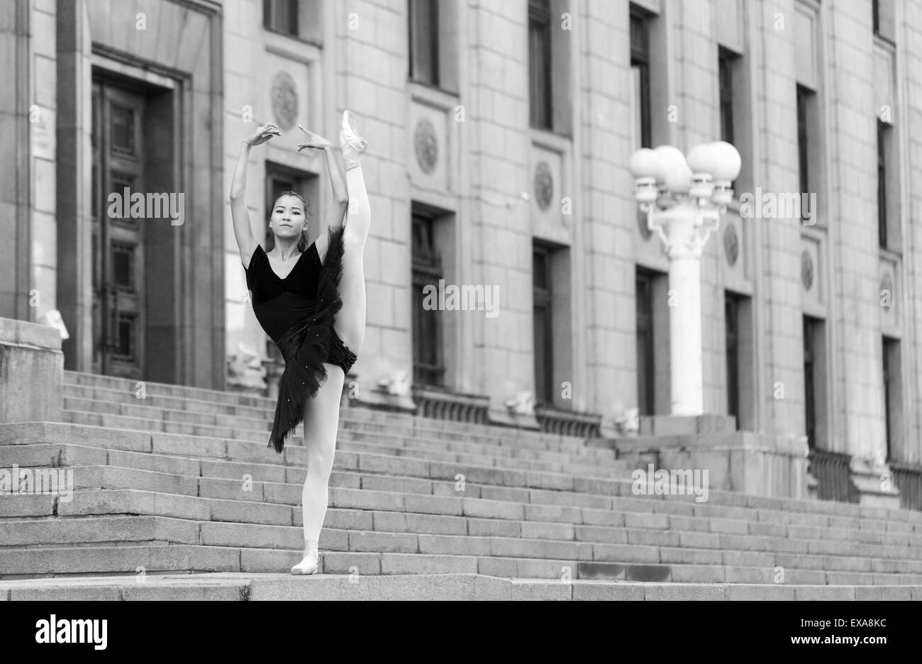 Girl ballerina flats standing on tiptoes on the street Stock Photo