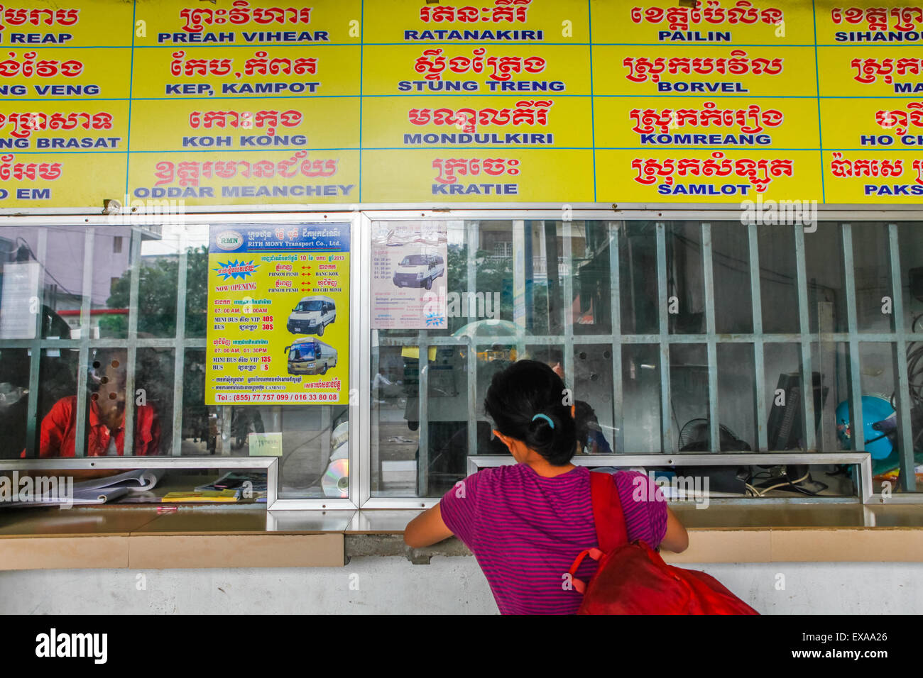A woman buying intercity bus tickets at a bus station in Phnom Penh