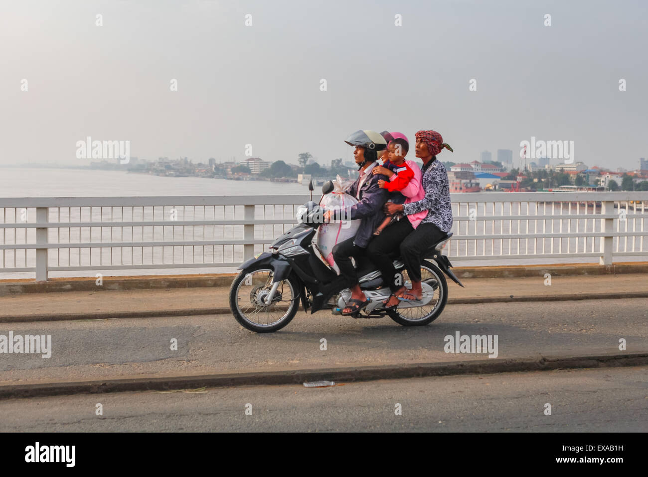 Motorists riding on Chrong Changvar bridge across Tonle Sap river in Phnom Penh, Cambodia. Stock Photo