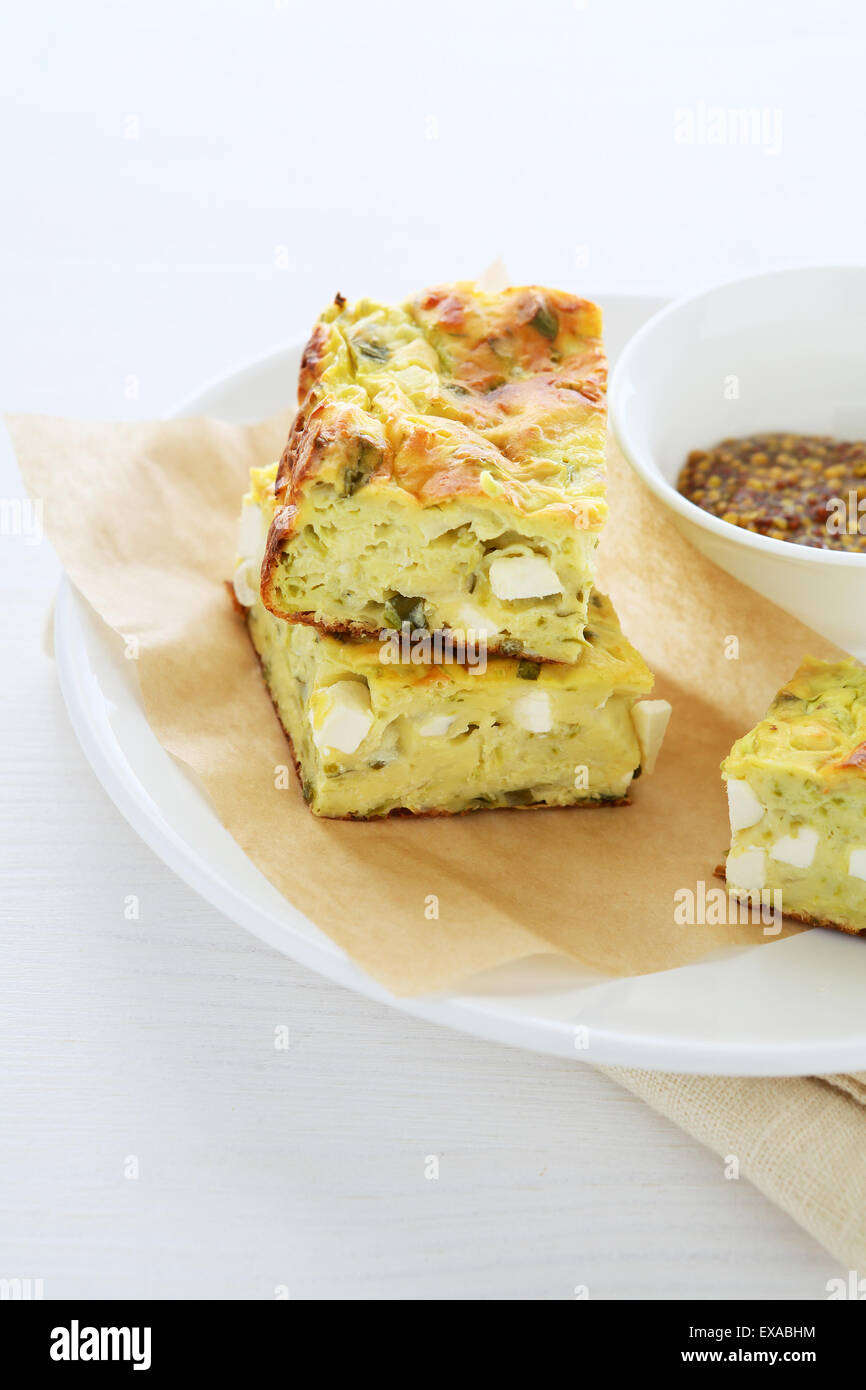 zucchini slice with sauce on plate, food closeup Stock Photo