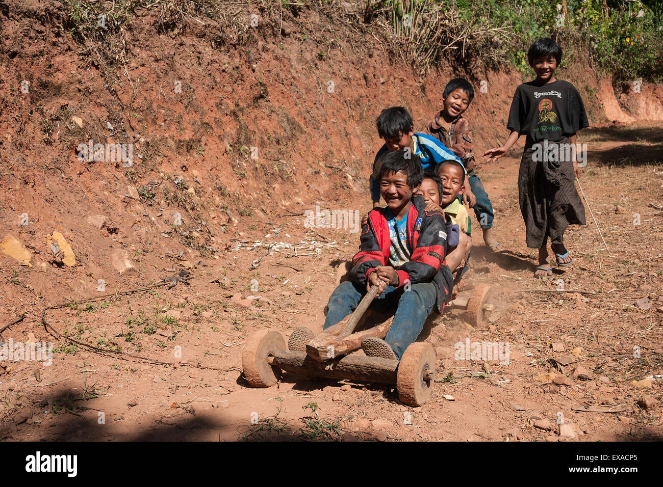 Children from Palaung tribe ride homemade vehicle in Kalaw, Shan State, Myanmar Stock Photo