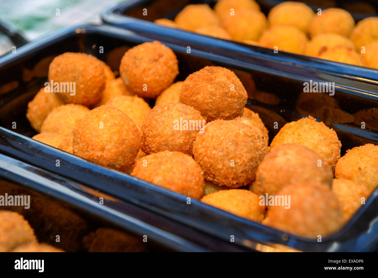 ruddy crispy cheese balls with spices in a metal tray Stock Photo