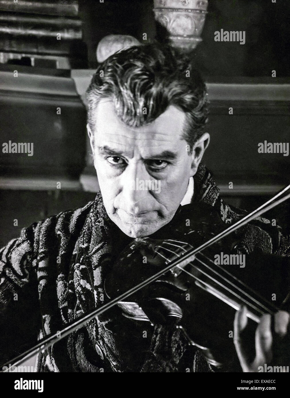 Sherlock Holmes playing the violin; from British silent movie 'The Sign of Four' starring Eille Norwood (1861-1948) as Sherlock Holmes, released in 1923. The last film in which Eille Norwood played Sherlock; Sir Arthur Conan Doyle was an admirer of Norwood's portrayal and for many he was the definitive on screen Holmes. Stock Photo