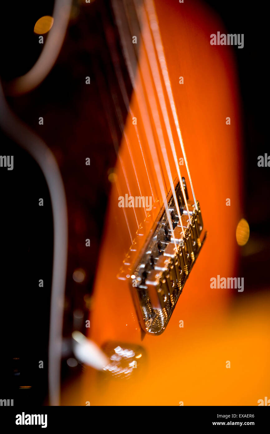 Guitar strings and bridge Stock Photo - Alamy