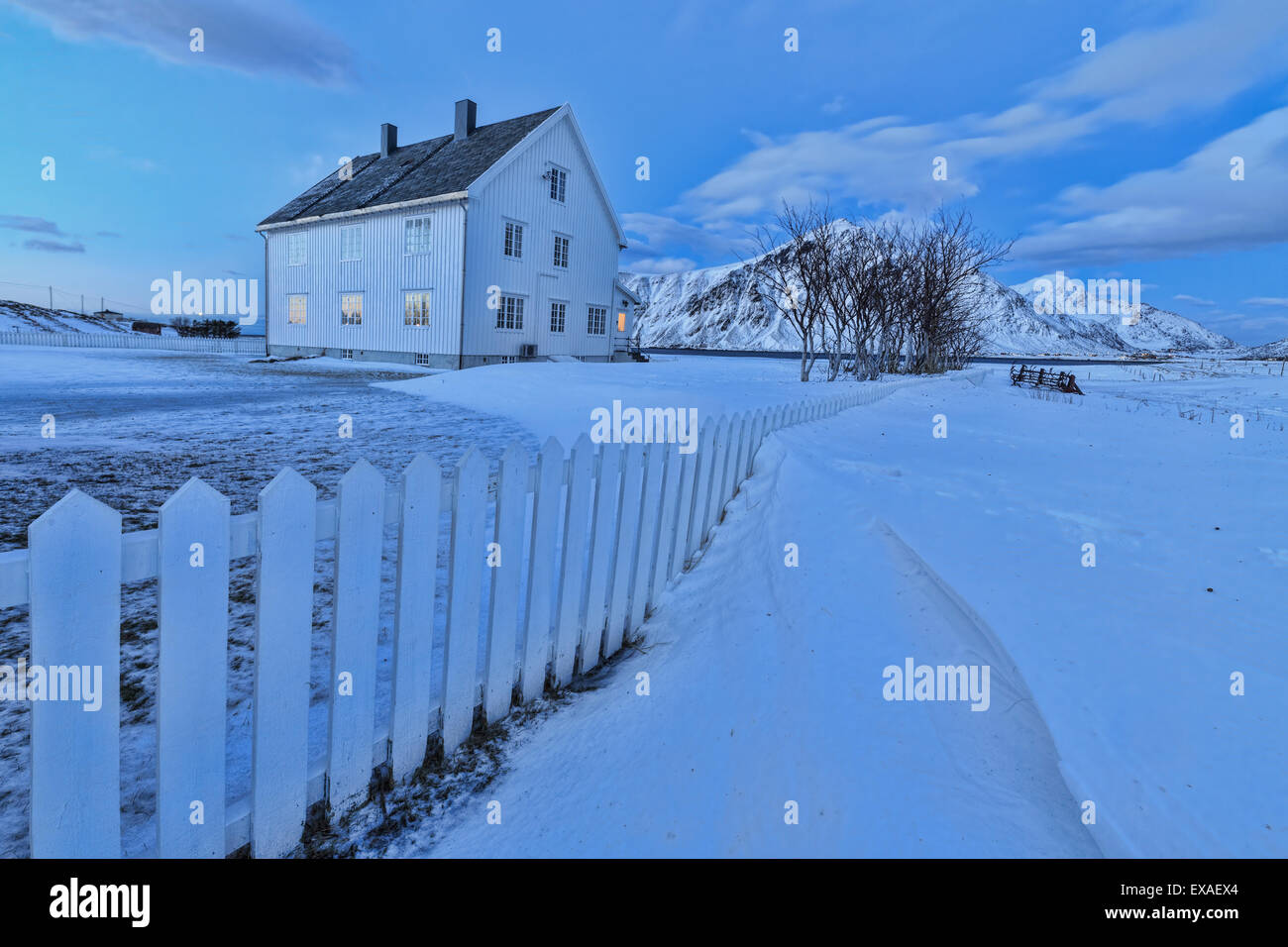 Typical house surrounded by snow at dusk, Flakstad, Lofoten Islands, Norway, Scandinavia, Europe Stock Photo
