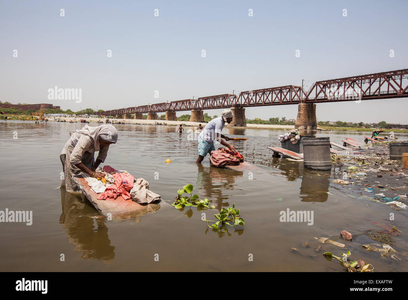 Women wash clothes in the polluted water of the Yamuna River, a tributary of the Ganges, New Delhi, India, Asia Stock Photo