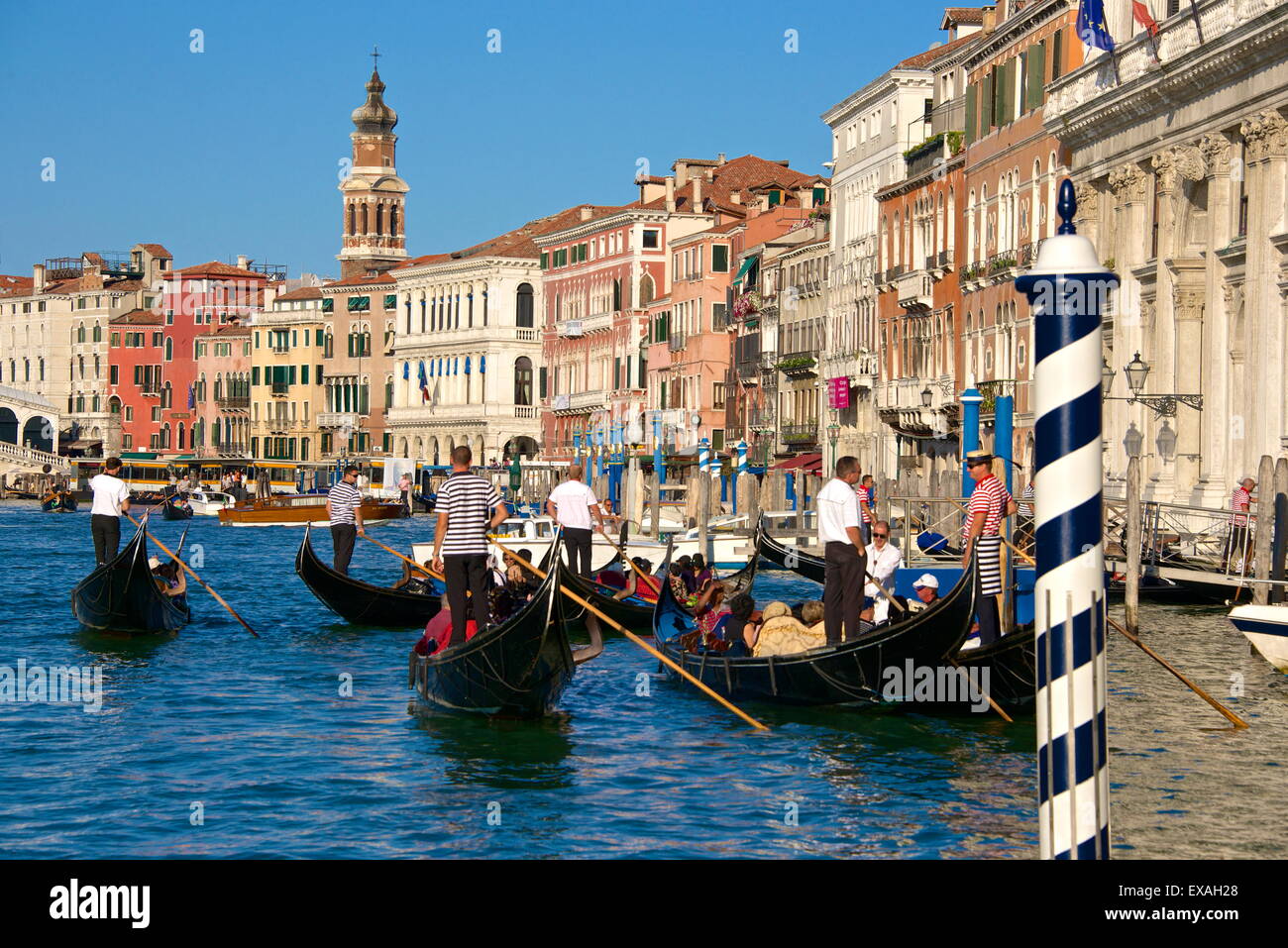 Gondolas and gondoliers, palaces facades and church steeple, Grand Canal, Venice, UNESCO World Heritage Site, Veneto, Italy Stock Photo