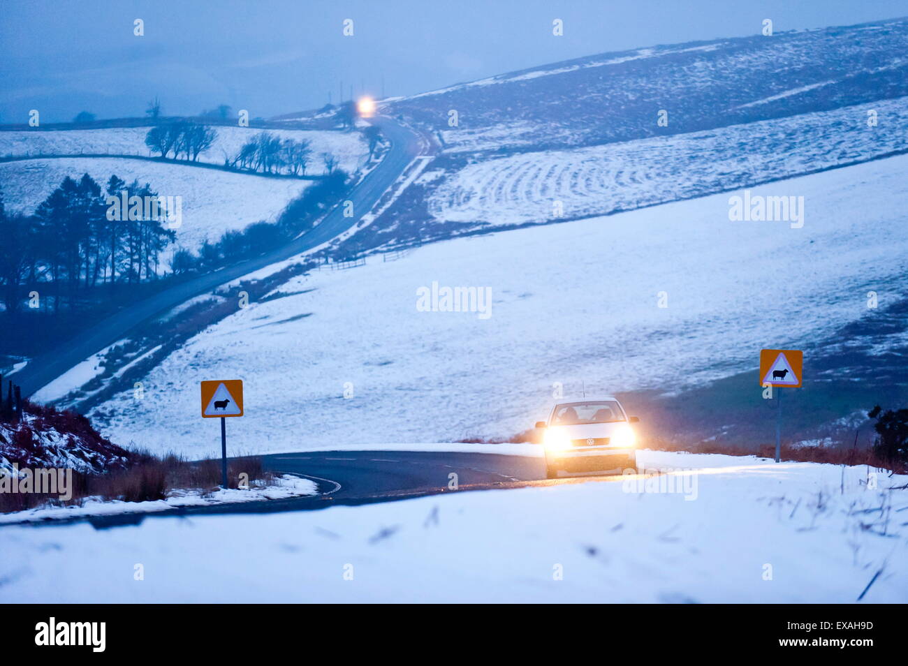 A motorist drives through a wintry landscape on the B4520, Brecon Road, on the Mynydd Epynt moorland, Powys, Wales, UK Stock Photo