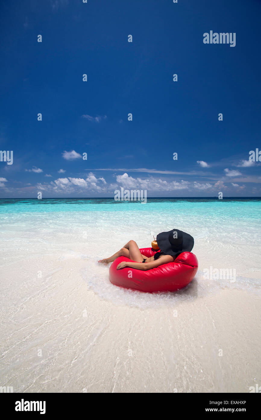 Woman relaxing on the beach, Maldives, Indian Ocean, Asia Stock Photo