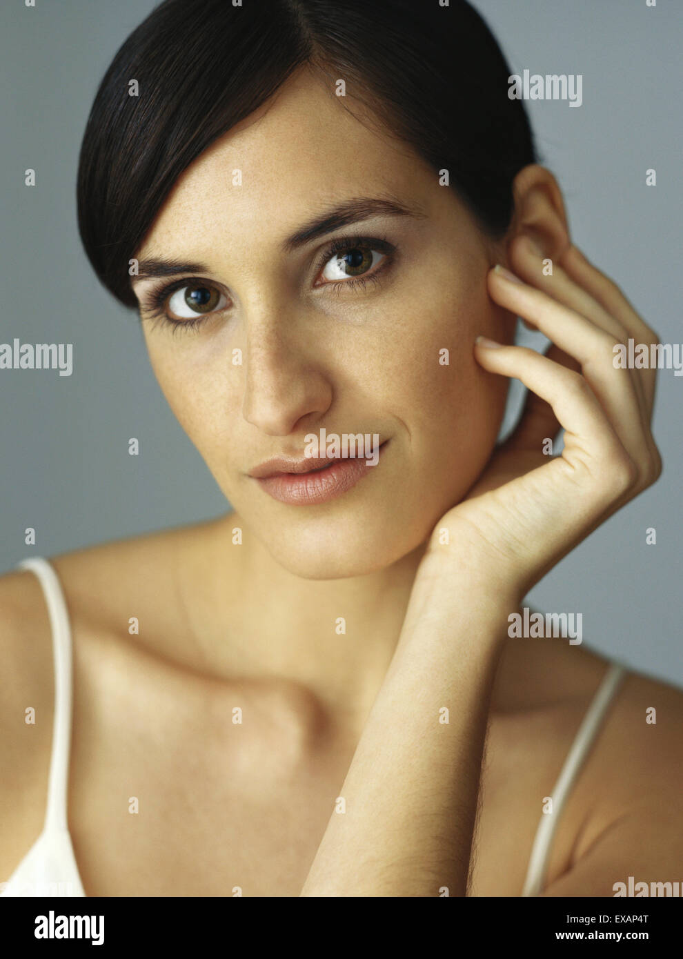 Woman holding head, portrait Stock Photo