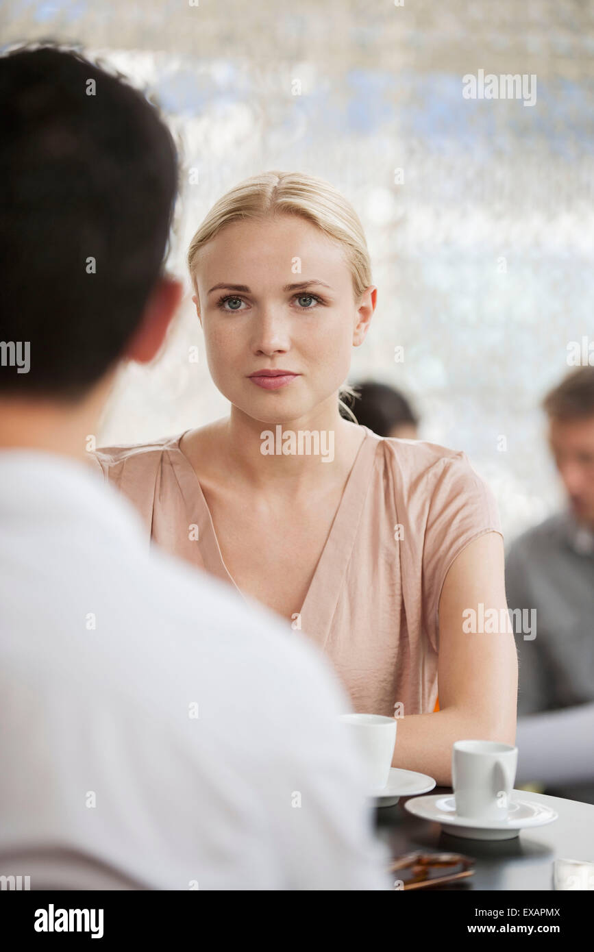 Woman having coffee in cafe with man Stock Photo