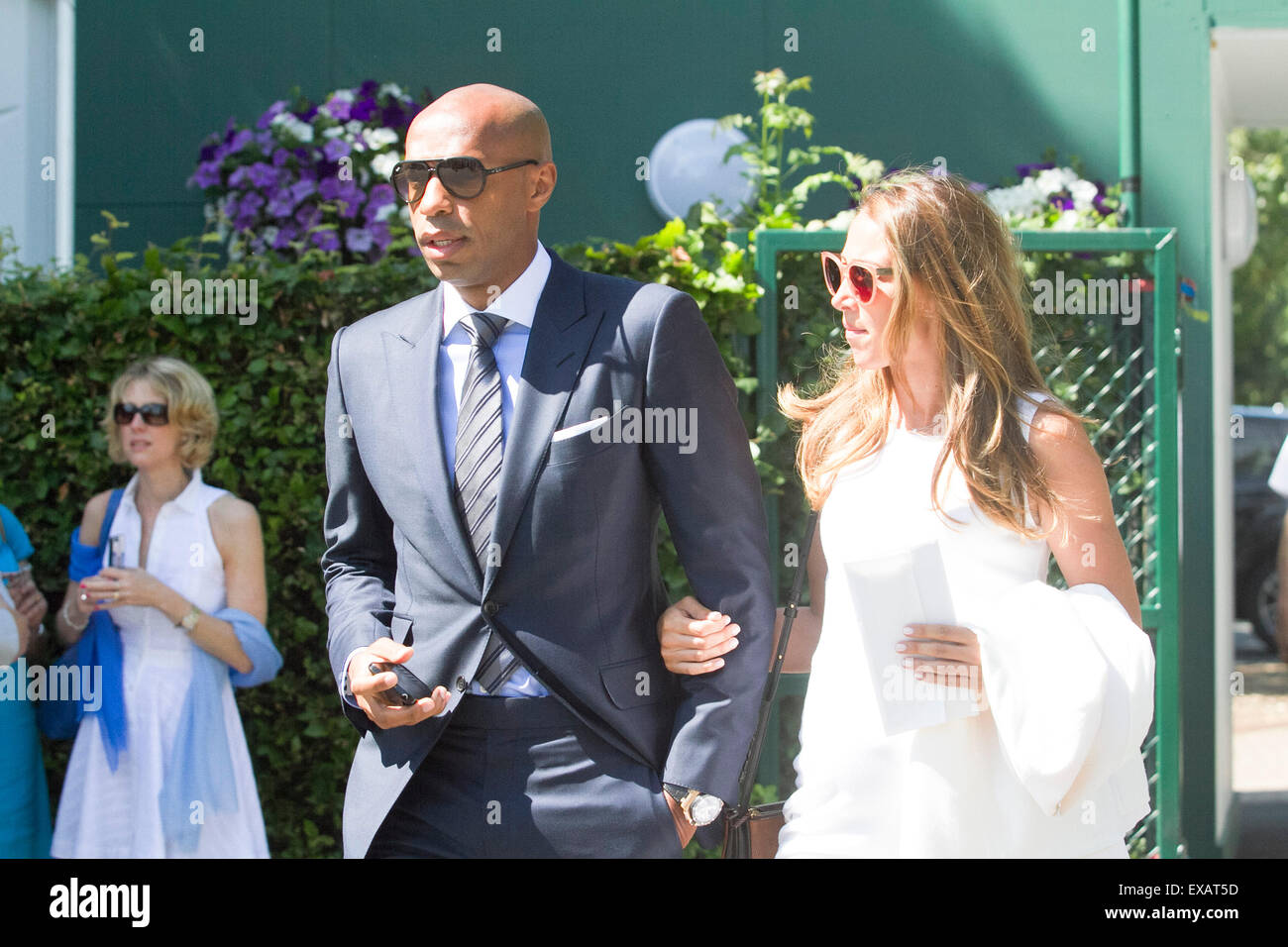 Wimbledon London,UK. 10th July 2015. Former Arsenal footballer Thierry Henry arrives with his girlfriend Andrea Rajacic at the AELTC  on Men's Semi final day of the 2015 Wimbledon Tennis championships Credit:  amer ghazzal/Alamy Live News Stock Photo