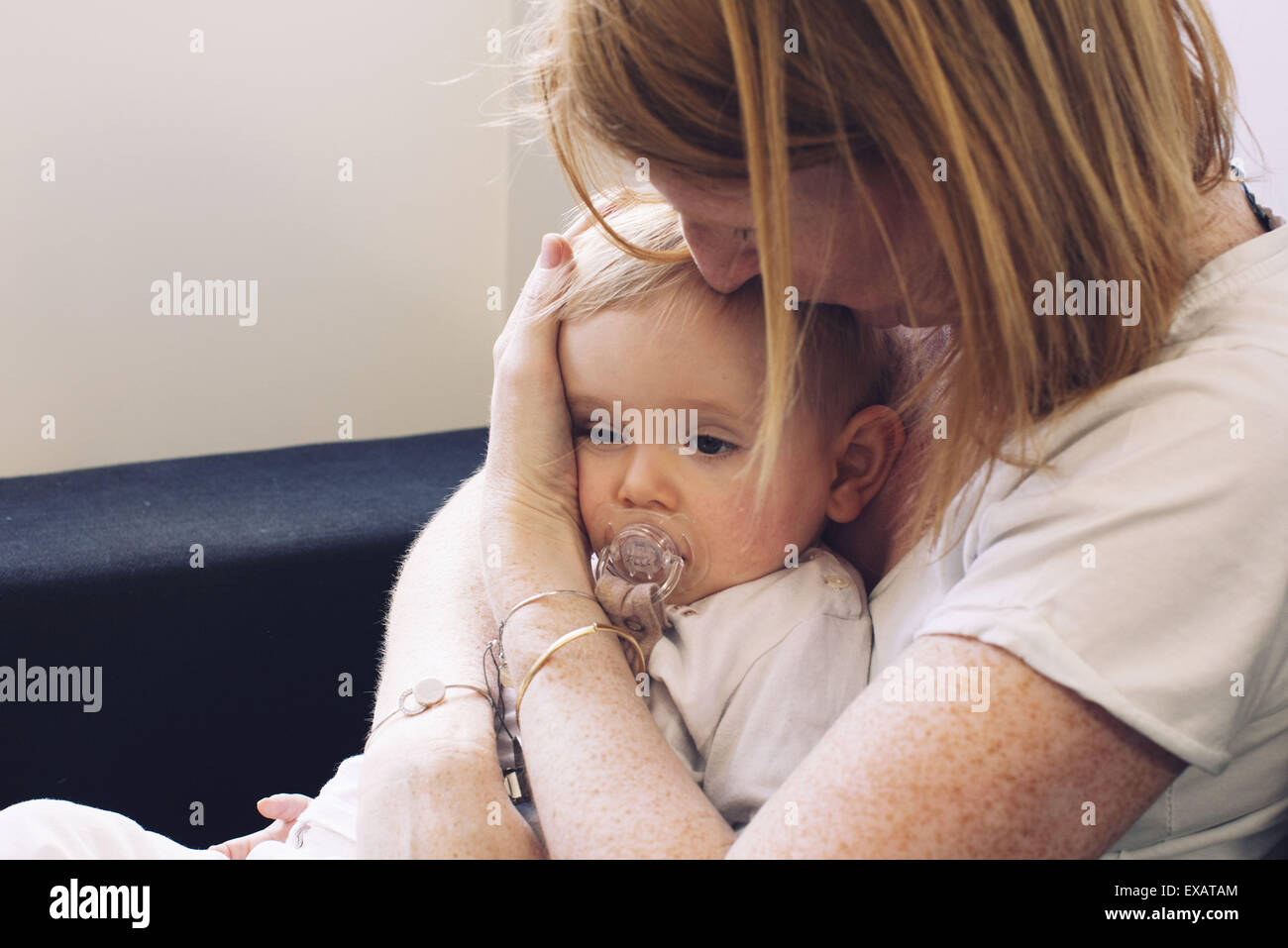 Mother holding infant on lap Stock Photo