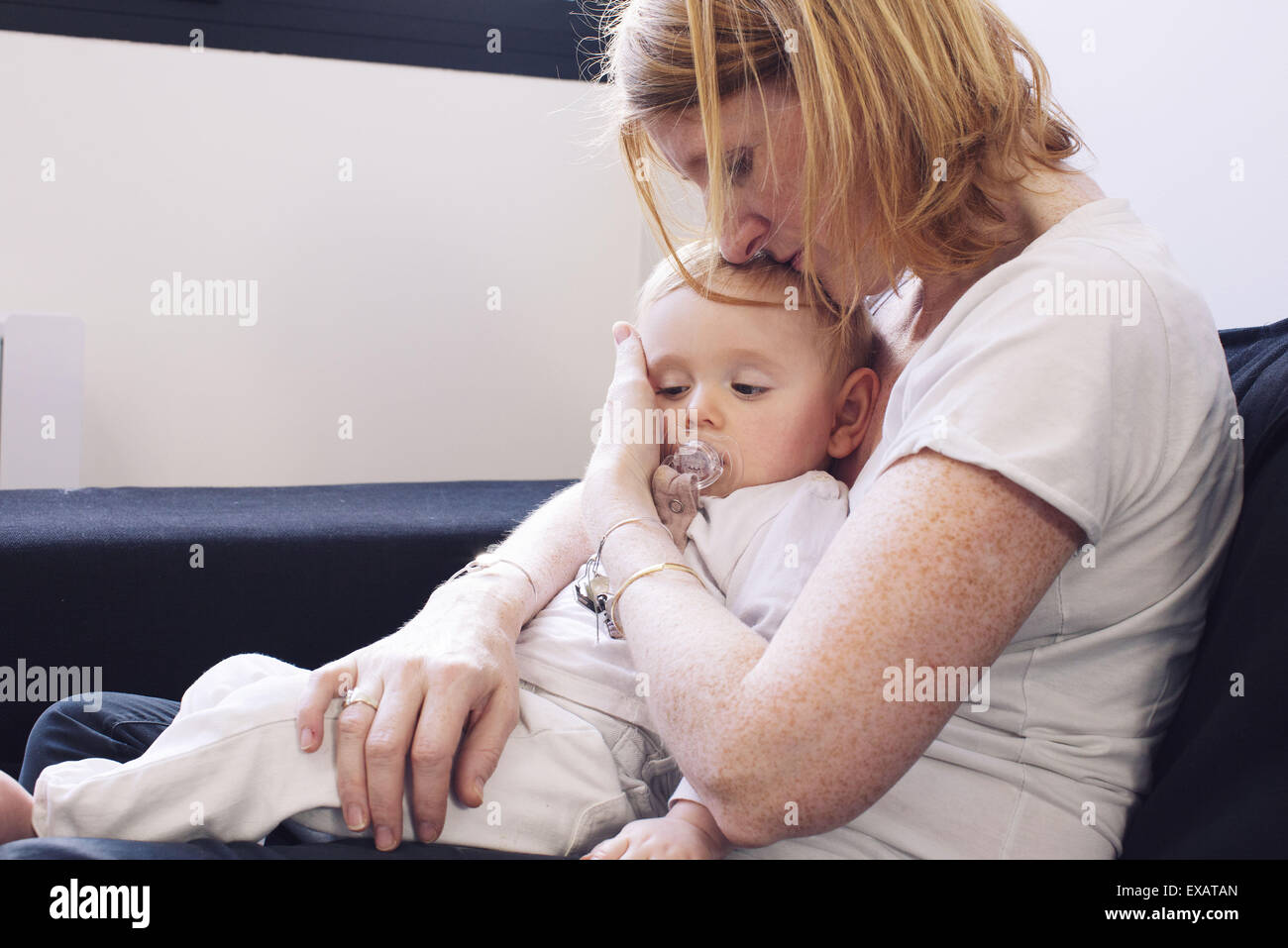 Mother holding baby on lap Stock Photo