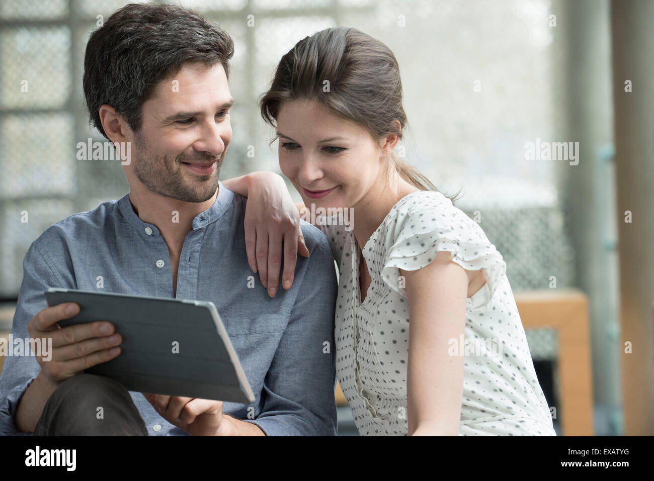 Couple using digital tablet together at home Stock Photo