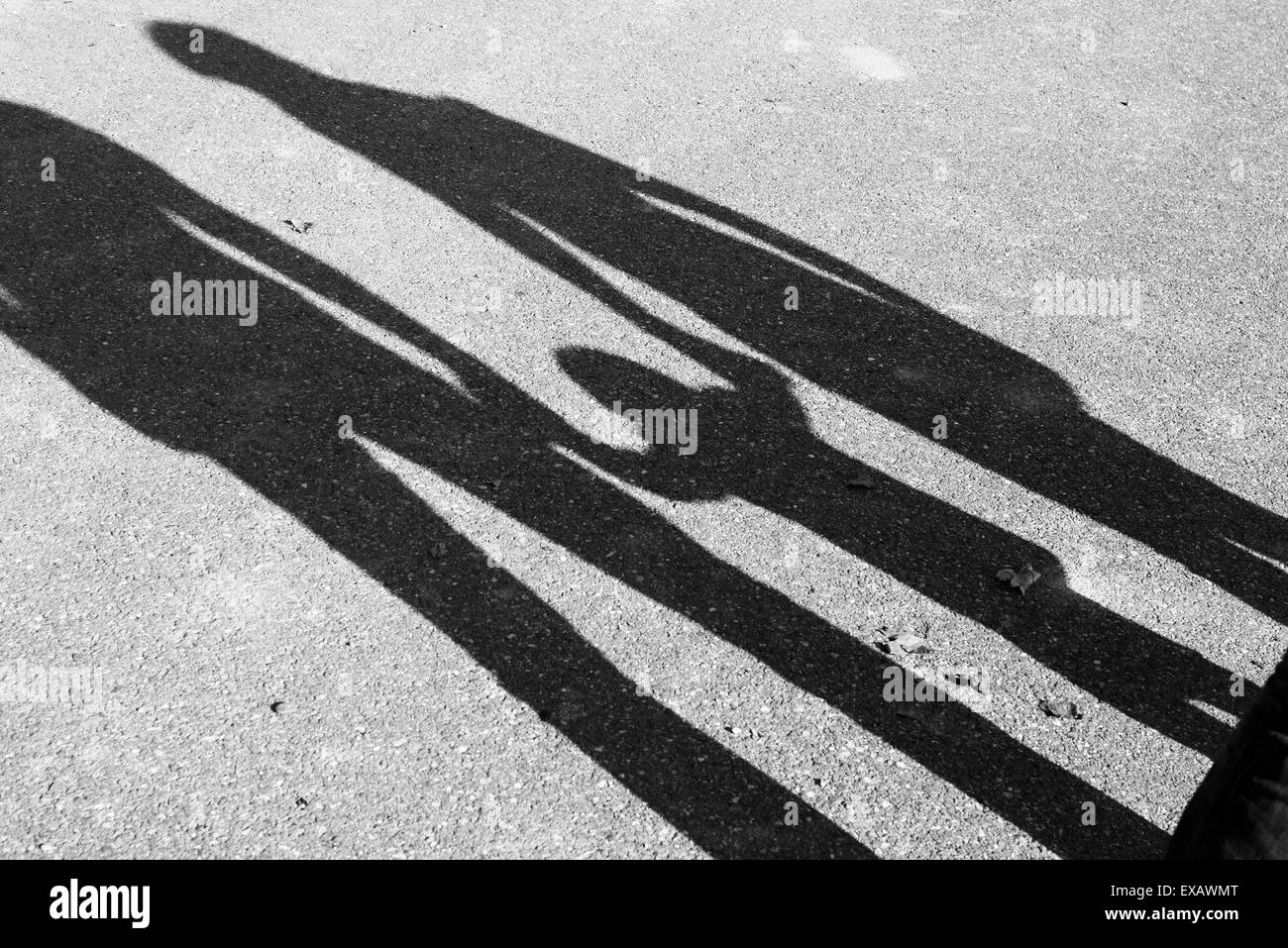 Shadow of parents and child holding hands Stock Photo