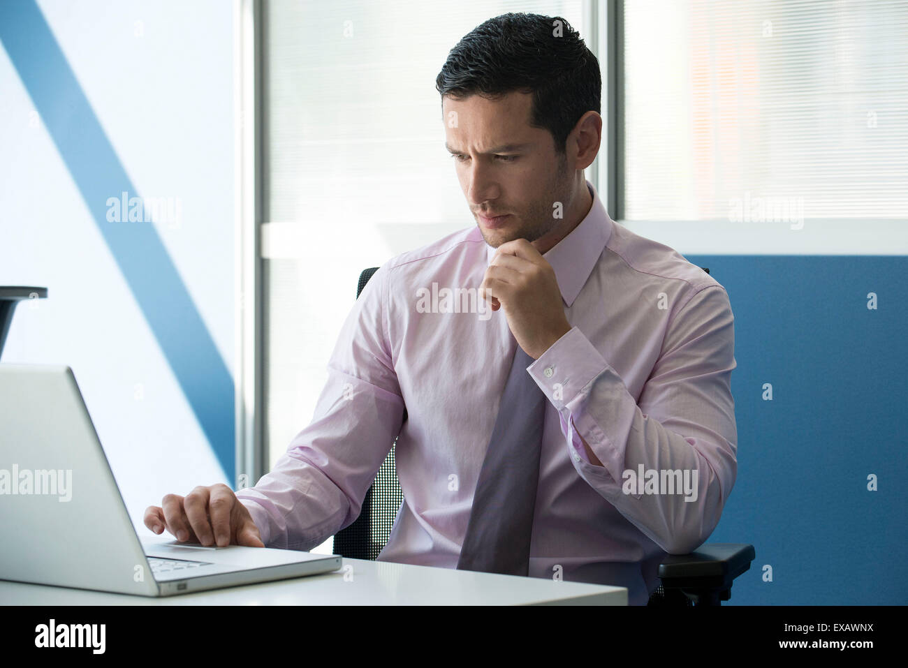 Office worker using computer concerned hi-res stock photography and ...