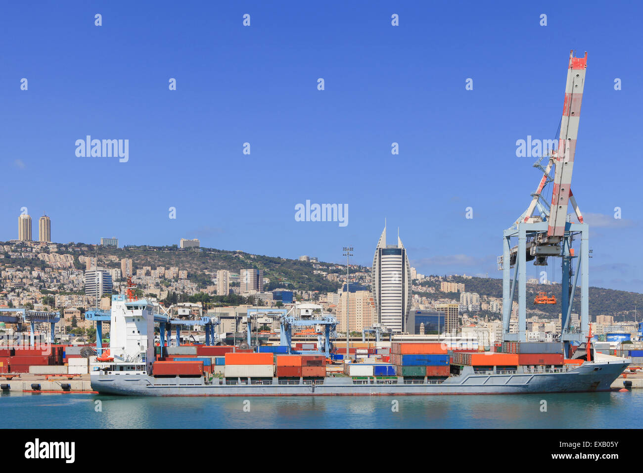 Panoramic View of the city of Haifa from Haifa's Port dock with container ship and Carmel mountain in the background Stock Photo