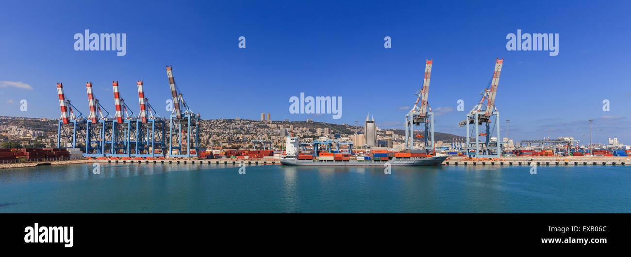 Panoramic View of the city of Haifa from Haifa's Port dock with container ship and Carmel mountain in the background Stock Photo