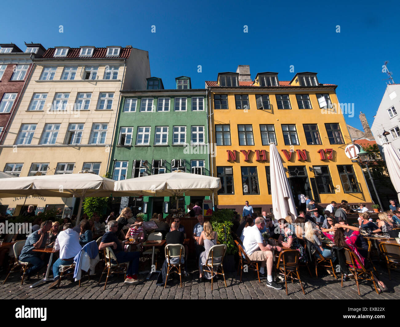tourists enjoy the waterfront at Nyhavn harbour area,Copenhagen,Denmark Stock Photo