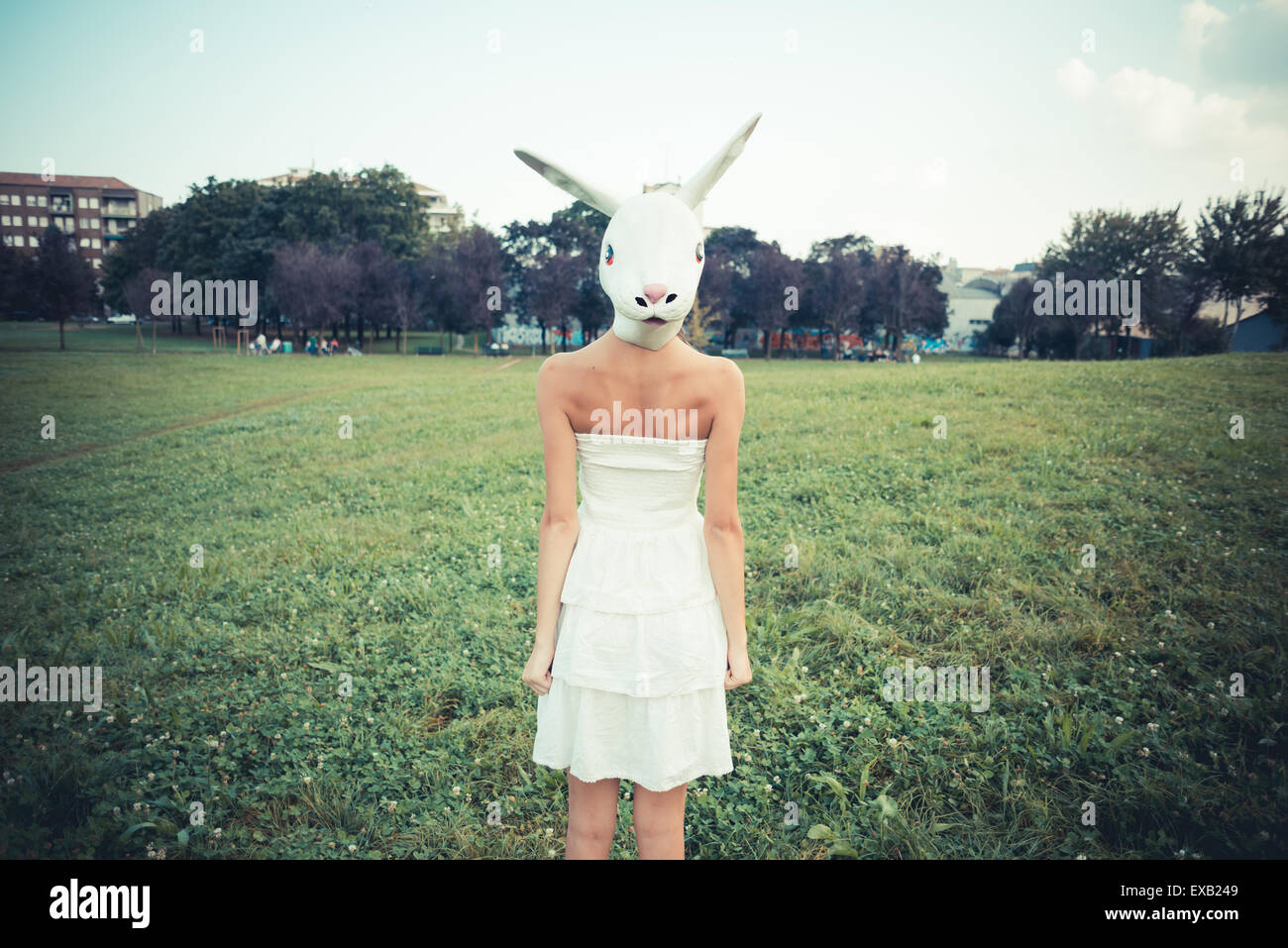 rabbit mask absurd beautiful young woman with white dress in the city ...