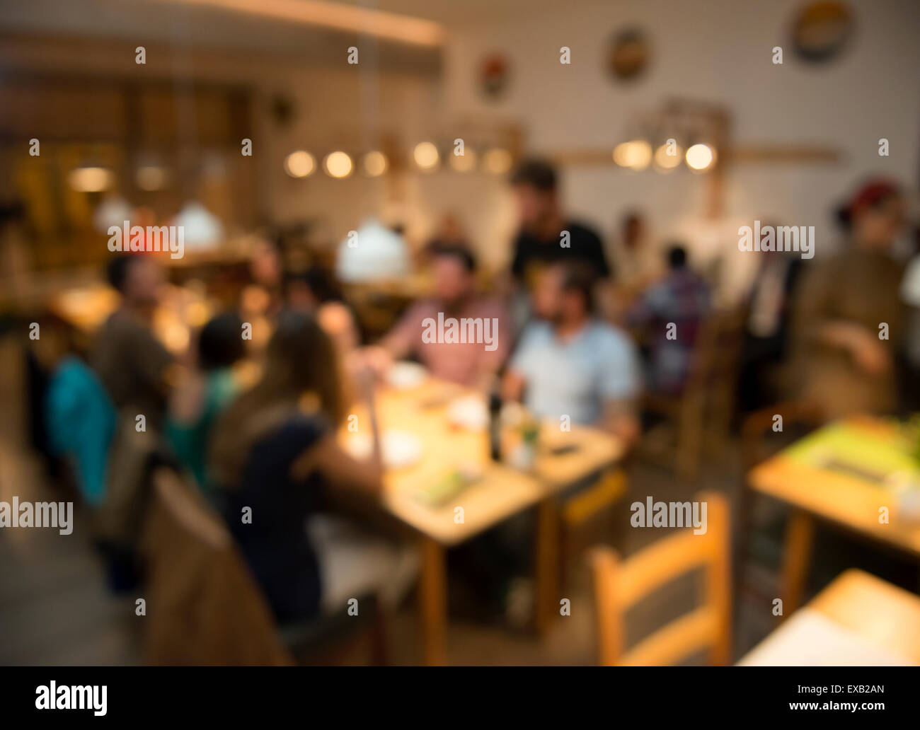 Blurred image of friends lunching and having fun at the restaurant Stock Photo