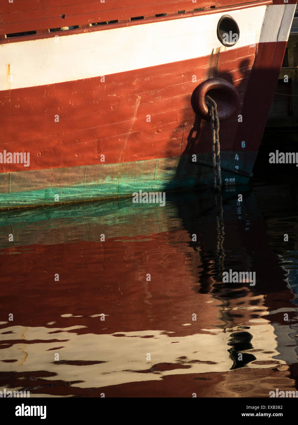 detail of reflection of a traditional boat in Nyhavn harbour area,Copenhagen,Denmark Stock Photo