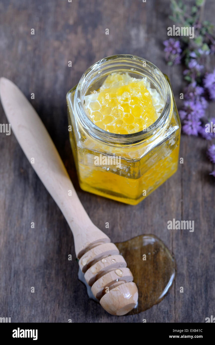 honeycomb and honey in glass jars Stock Photo