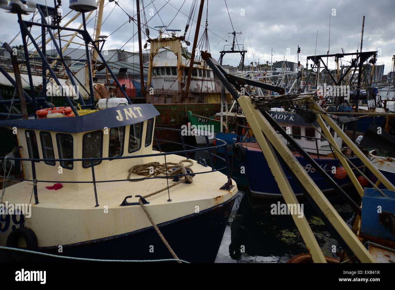 Fishing vessels moored in Sutton Harbour Plymouth including Sunk Scalloper JMT Stock Photo
