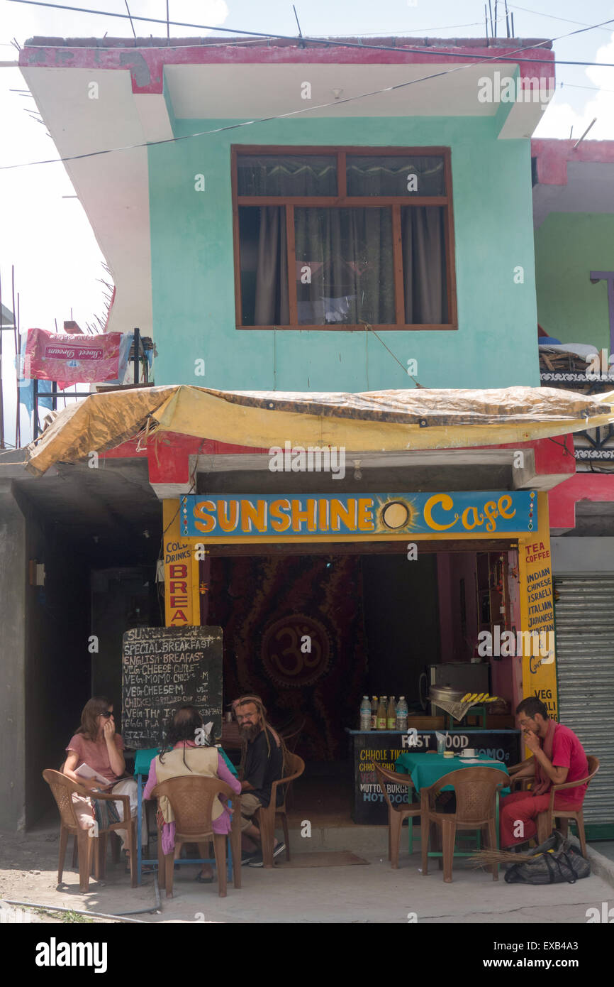 tourists sitting in the shade outside Sunshine Cafe in Manali, in the Indian state of Himachal Pradesh Stock Photo
