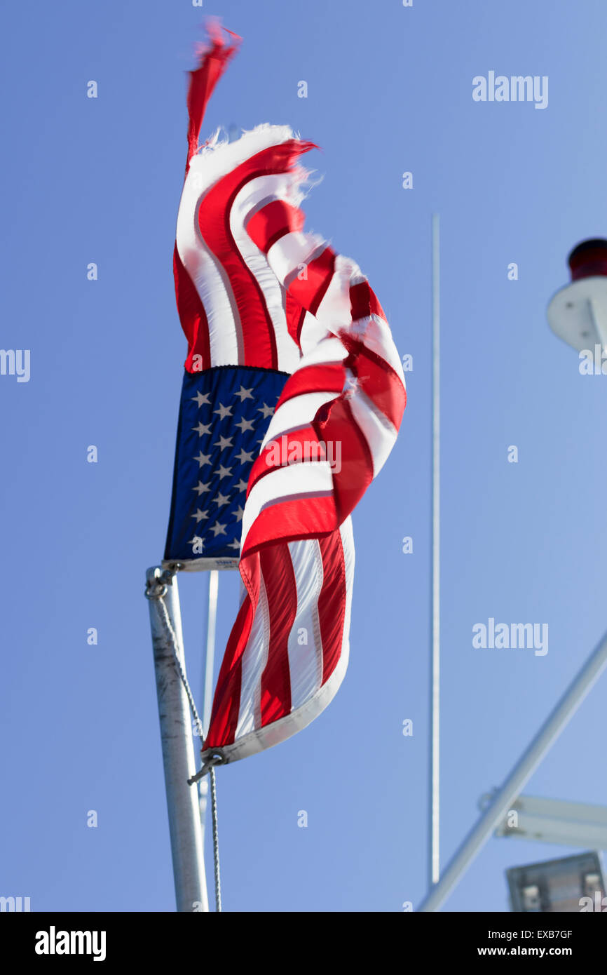 Weathered American flag on a flag pole Stock Photo Alamy