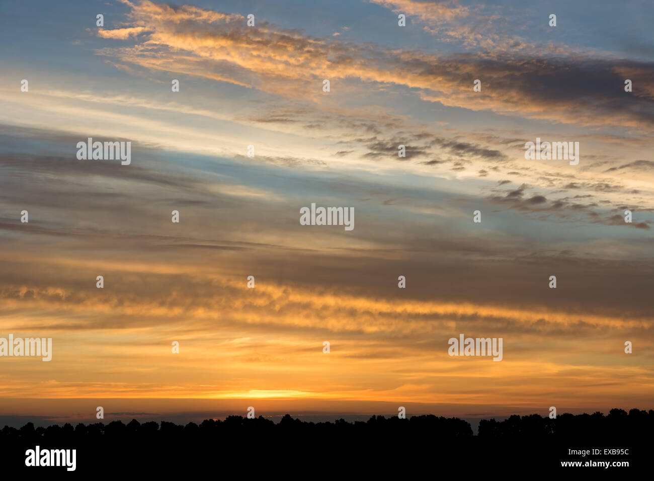 Sunset sunrise in the sky with dramatic clouds Stock Photo - Alamy