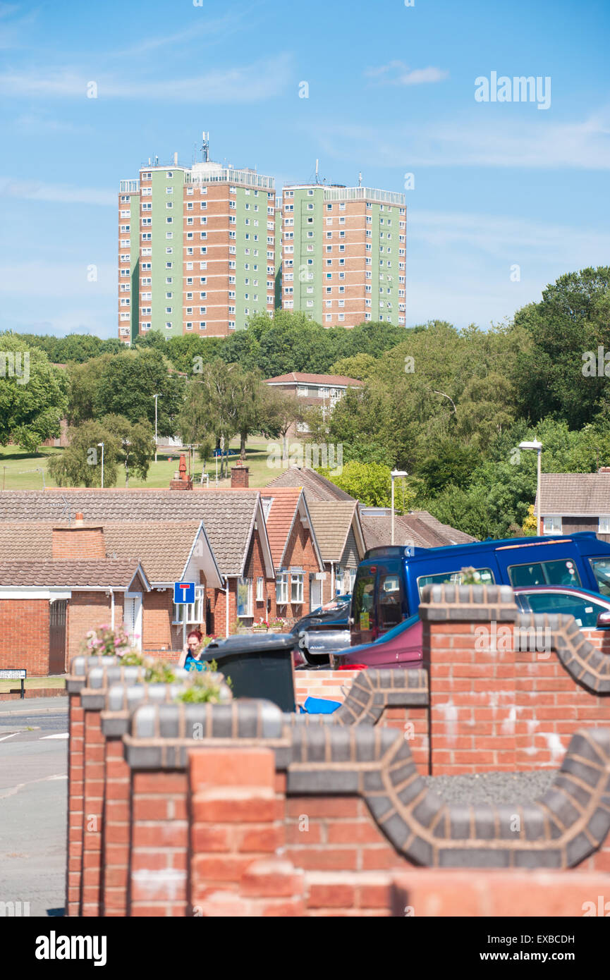 Three large tower blocks of council flats overlooking a park and the rooftops of a neat 1980s private housing estate in Dudley. Stock Photo