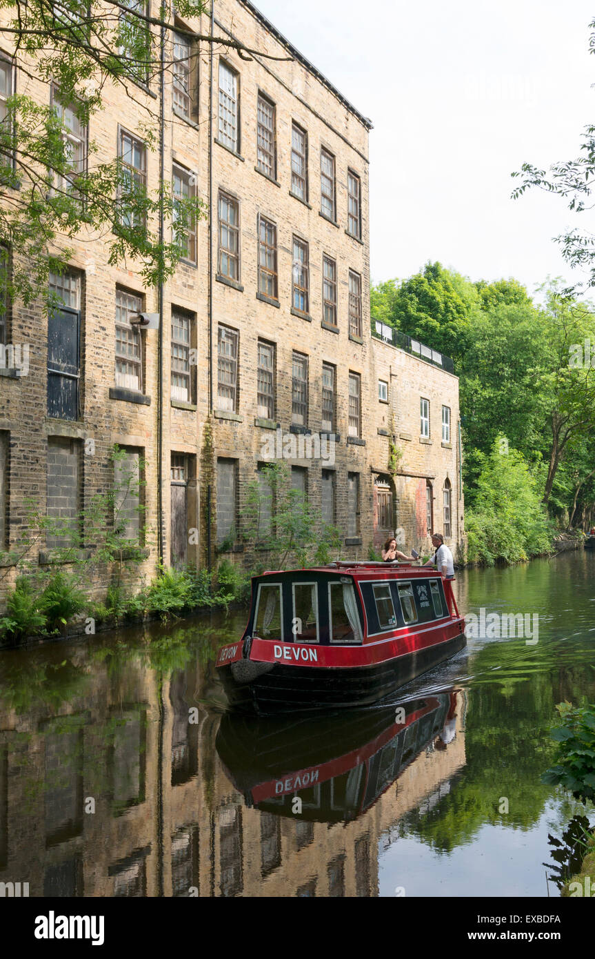 Narrowboat passing old mill on the Rochdale Canal, Luddenden Foot, West Yorkshire Stock Photo