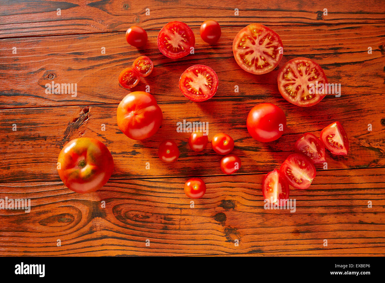 Tomatoes in a red monochrome rustic wooden table Stock Photo - Alamy